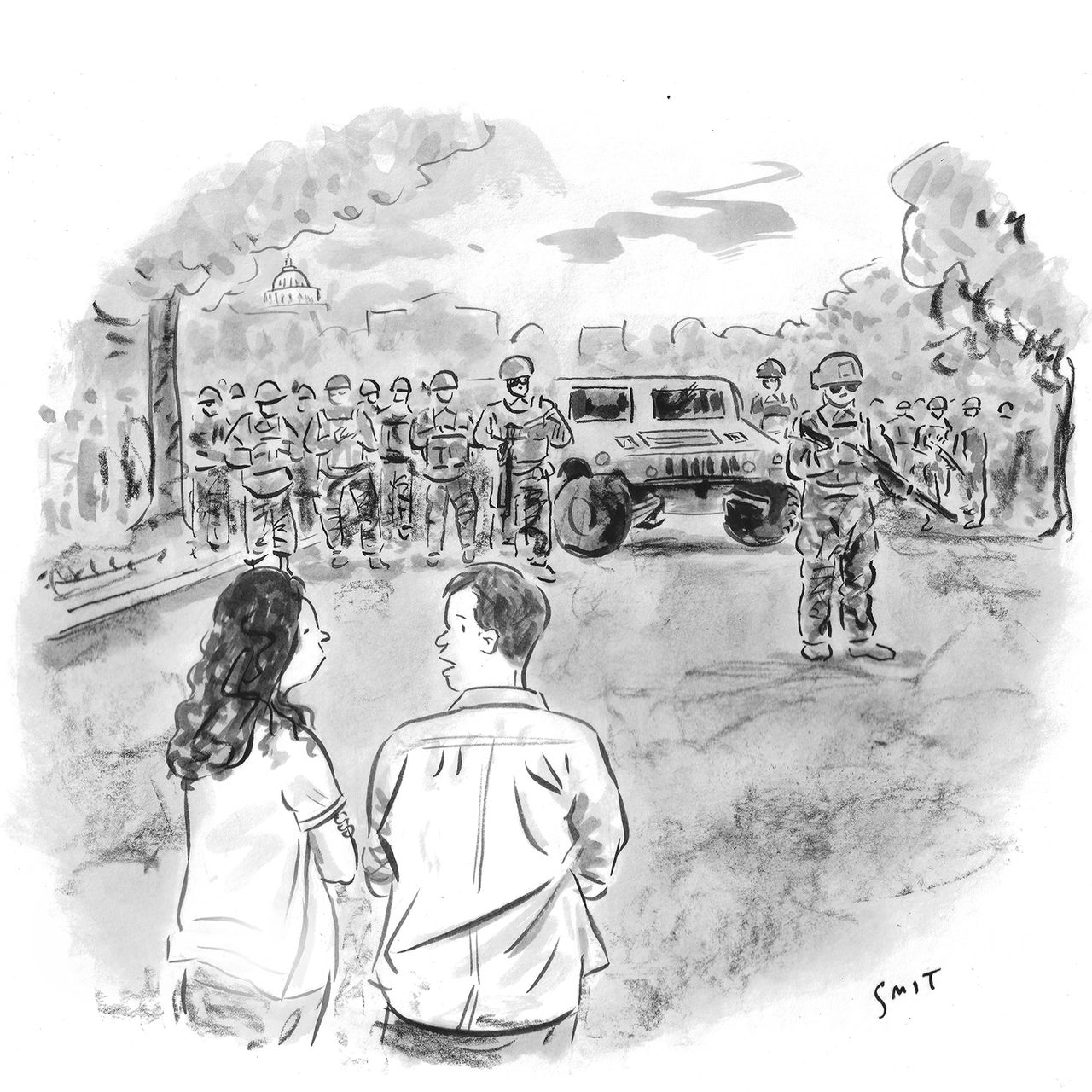 A couple watches the National Guard march through Washington D.C.