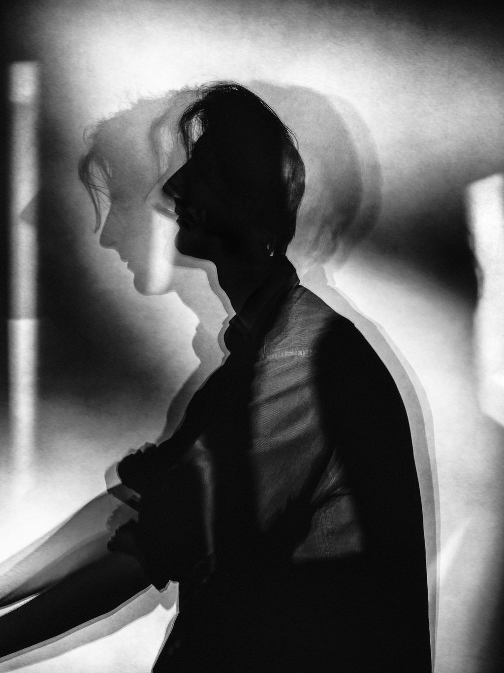 A doubleexposure photograph of mans silhouette.
