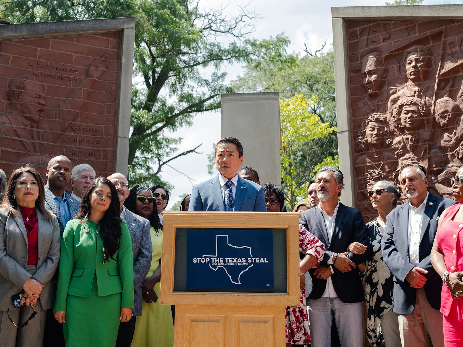 A group of people standing around a podium.